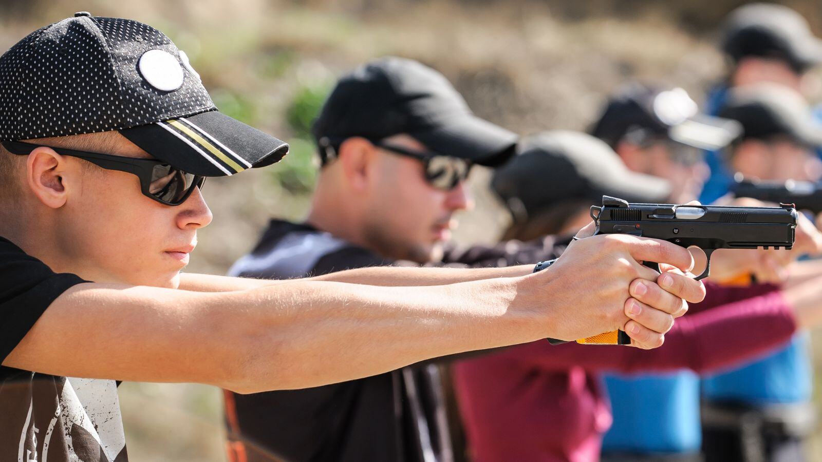 group of men taking shooting practice